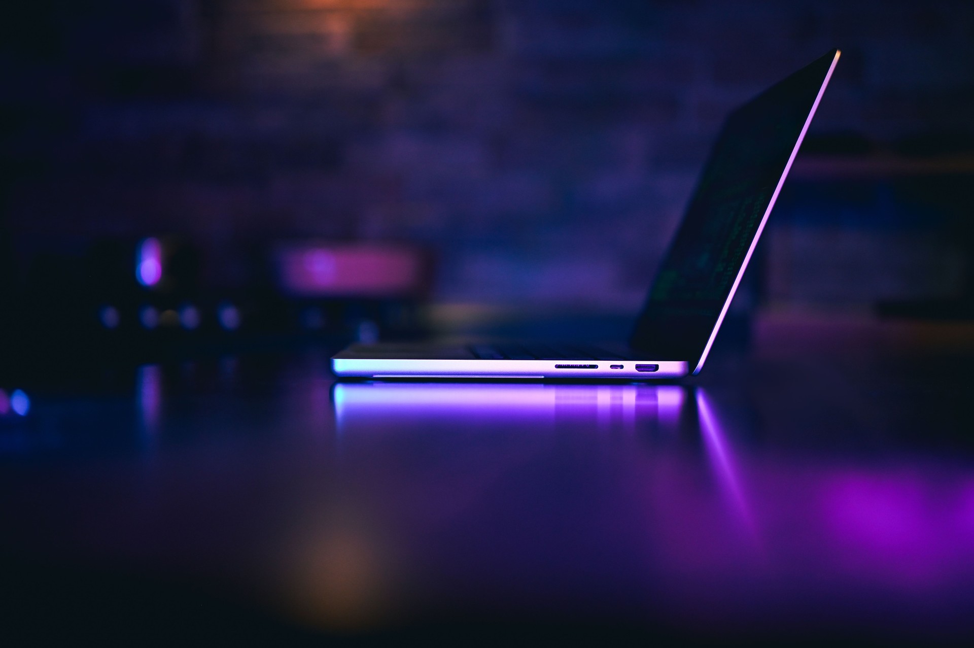 Side view portrait of laptop with neon light.